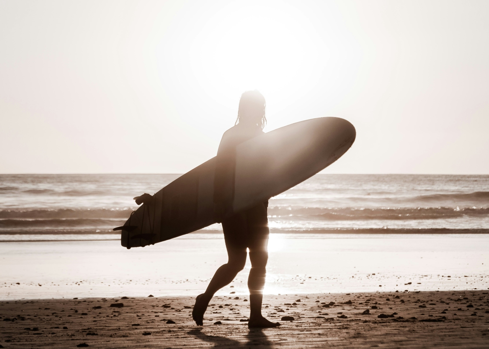 Santa Teresa surfer a bohemian surfer holding his board against the backdrop of Santa Teresa
